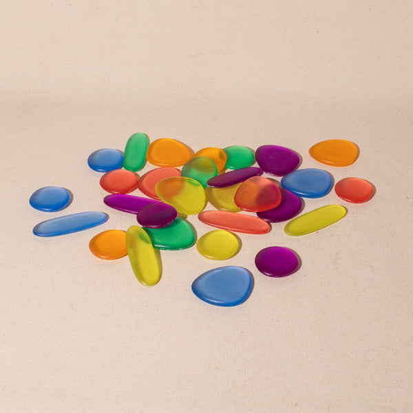 a plie of beautifully jewel toned translucent acrylic rainbow pebbles