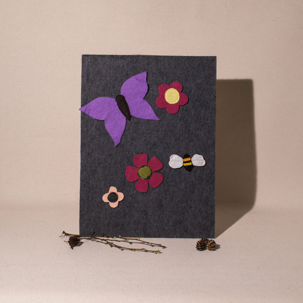 grey feltboard with butterfly bee and flowers