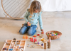 Child playing with Grapat Sorting Tray and loose parts materials