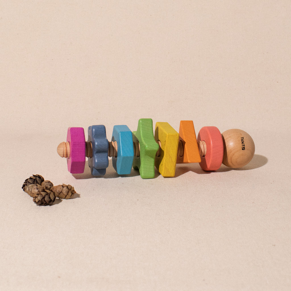 giant bolt with 7 rainbow coloured nuts of different shapes