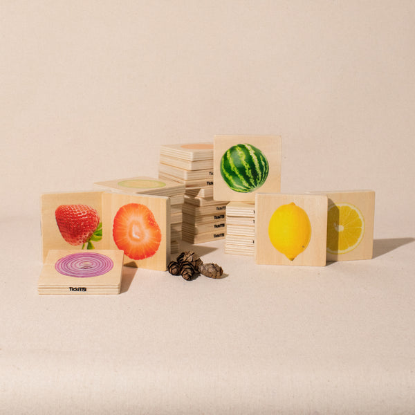 stacked wooden pieces with photos of whole and cut fruit and vegetables