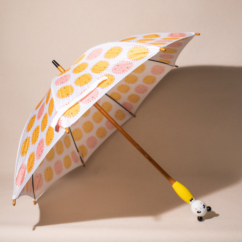open child's umbrella with colourful suns and a panda handle