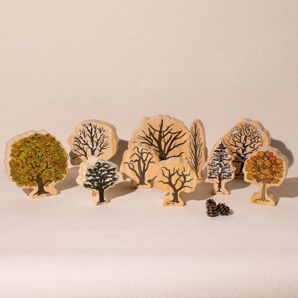 10 freestanding wooden trees showing fall/winter side