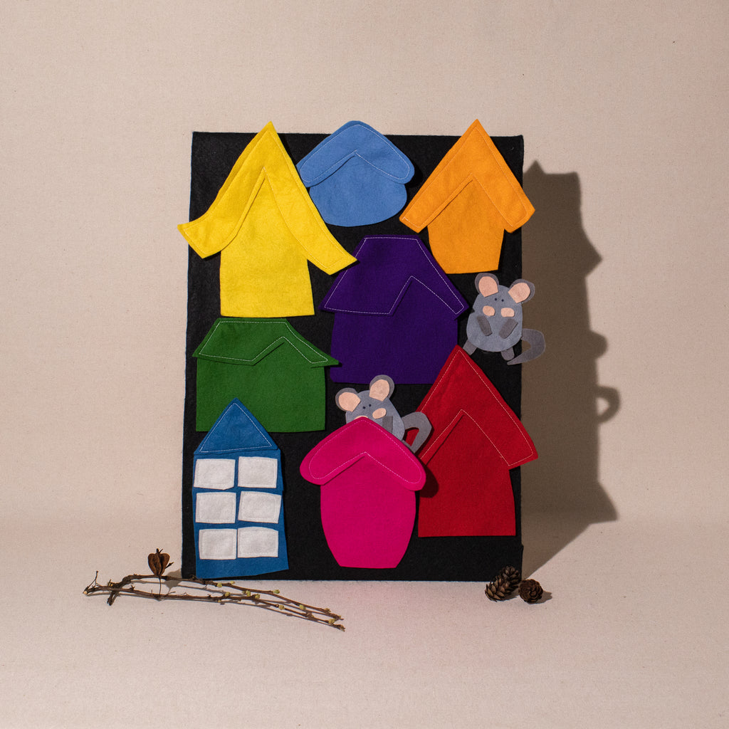felt board with 8 different coloured and styled houses and 2 grey mice