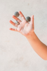child holding 3 grey grapat mandala stones