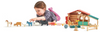 child playing with wooden farm animals and barn
