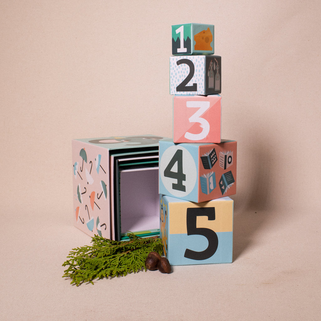 stacked number cubes with numerals and illustrations of colourful objects and animals