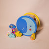 drum shape sorter with picture of the moon and 6 musical shapes including cloud, rocket, raindrop, rainbow, etc