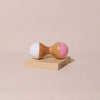 white and pink hourglass shaped wooden maraca rattle